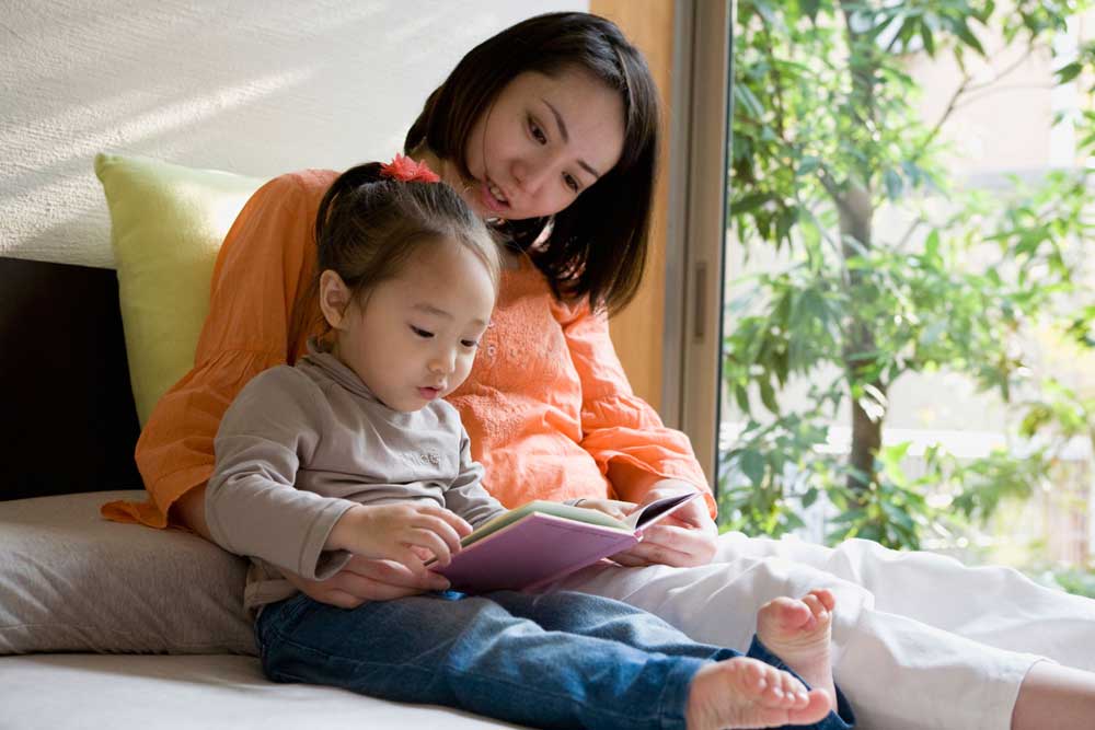 Mother and daughter reading a book.