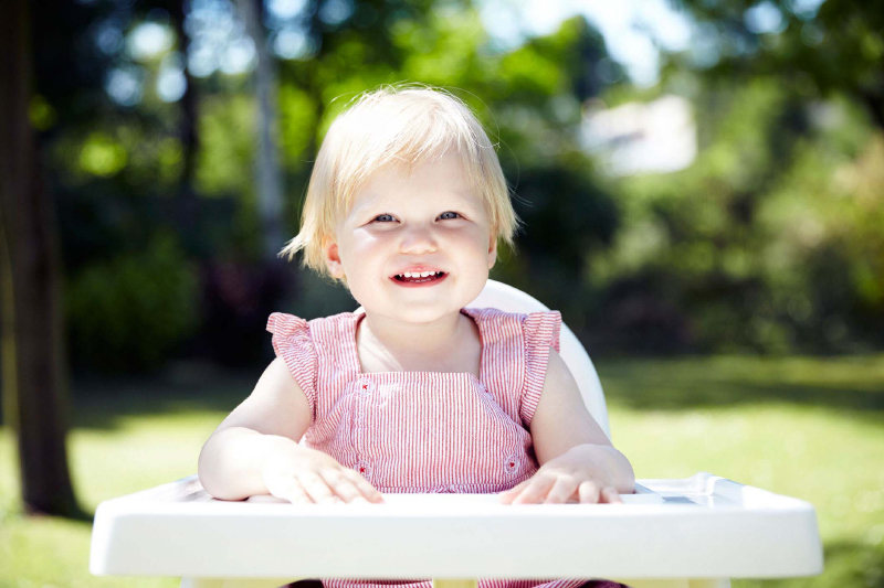 Baby waiting for lunch in a garden.