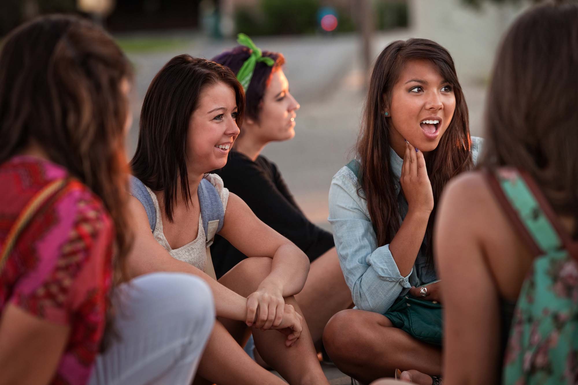 Group of teenagers sitting outside.