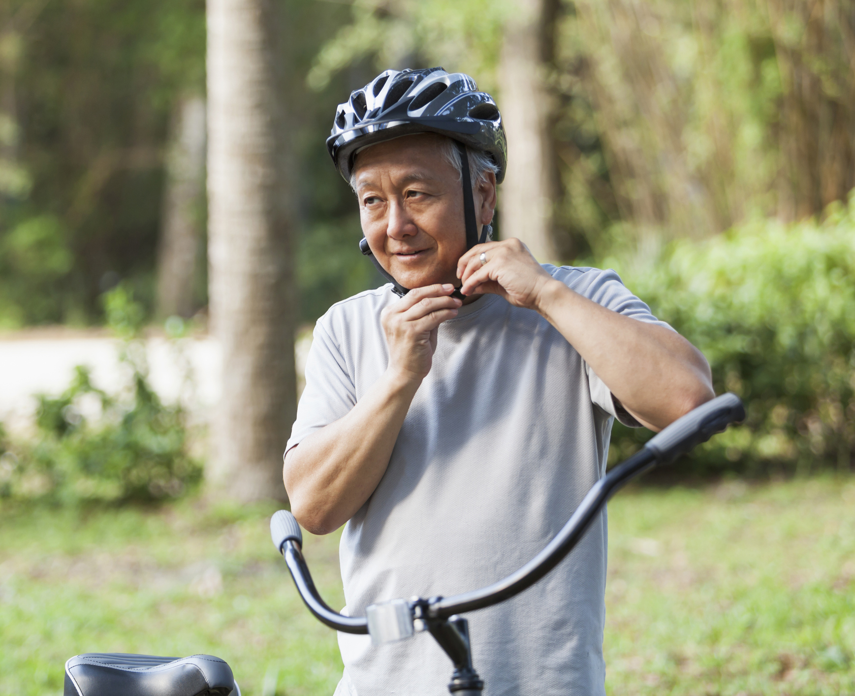 Older man buckling his bike helmet