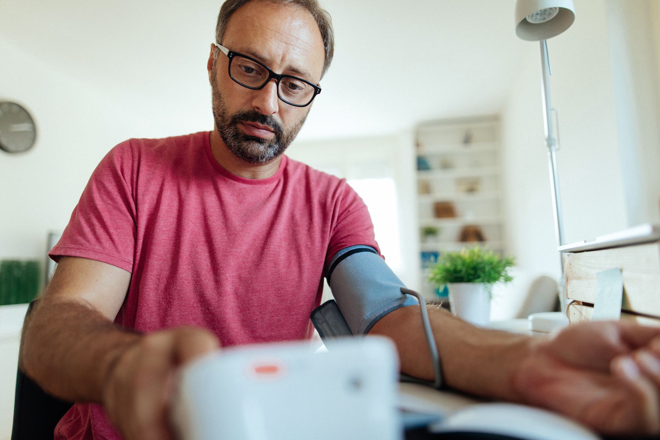 Man checking his blood pressure at home