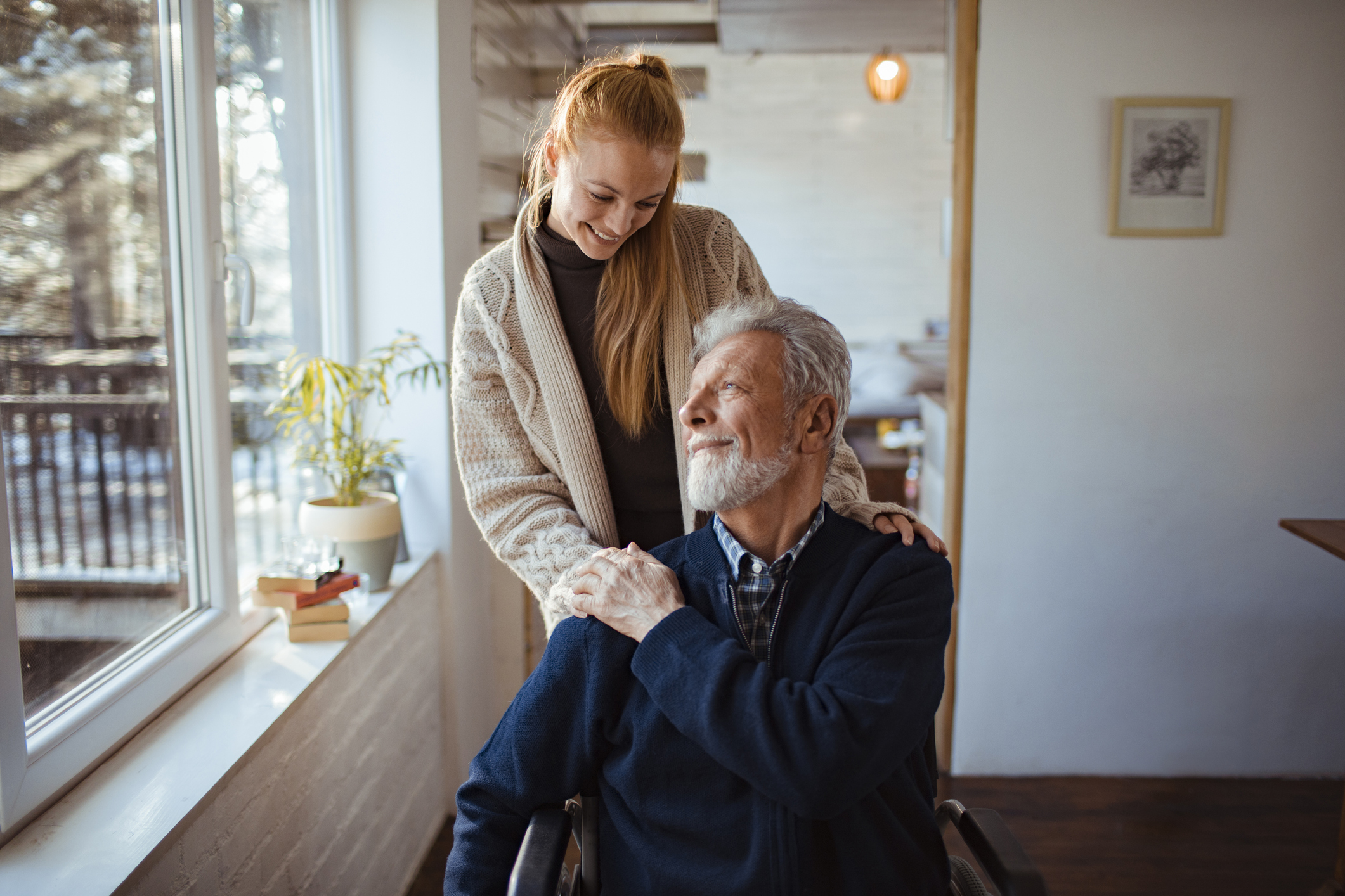 Young woman helping her older father