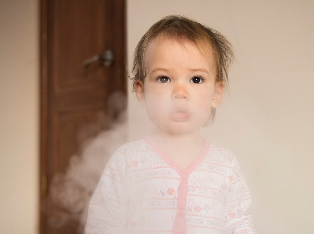 Young girl in a cloud of cigarette smoke