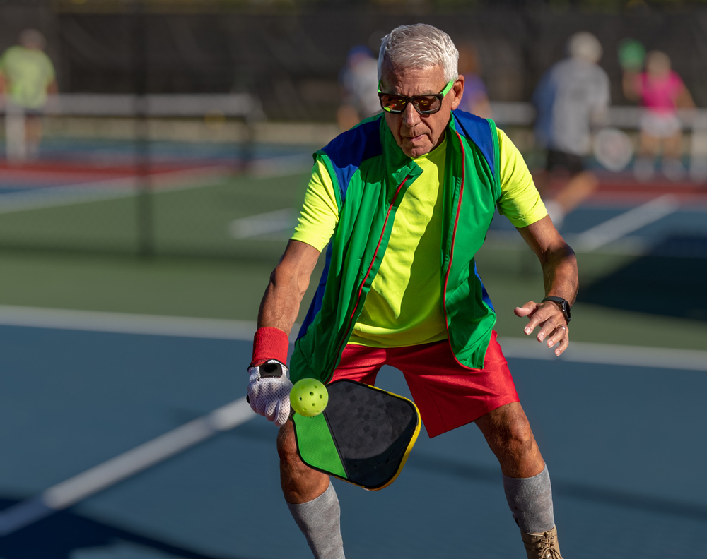 Older man playing pickleball