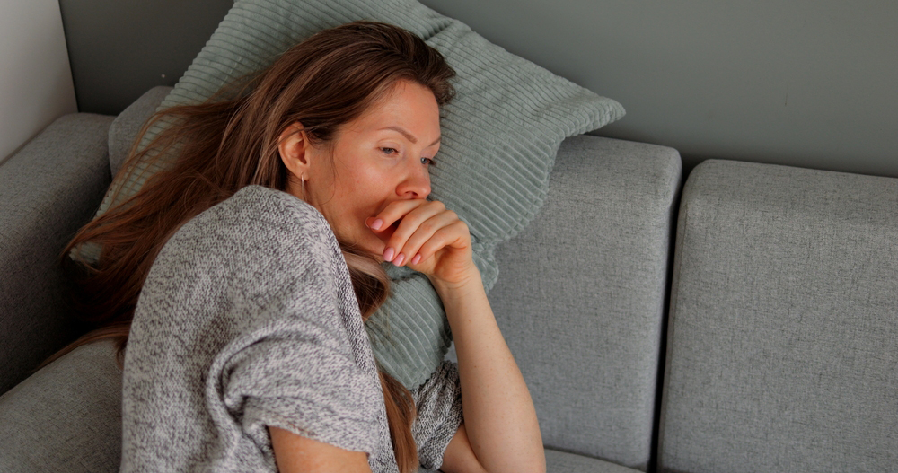 Tired woman laying on the couch.